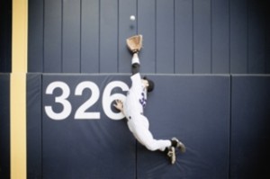 Baseball Outfielder Leaping for Fly Ball